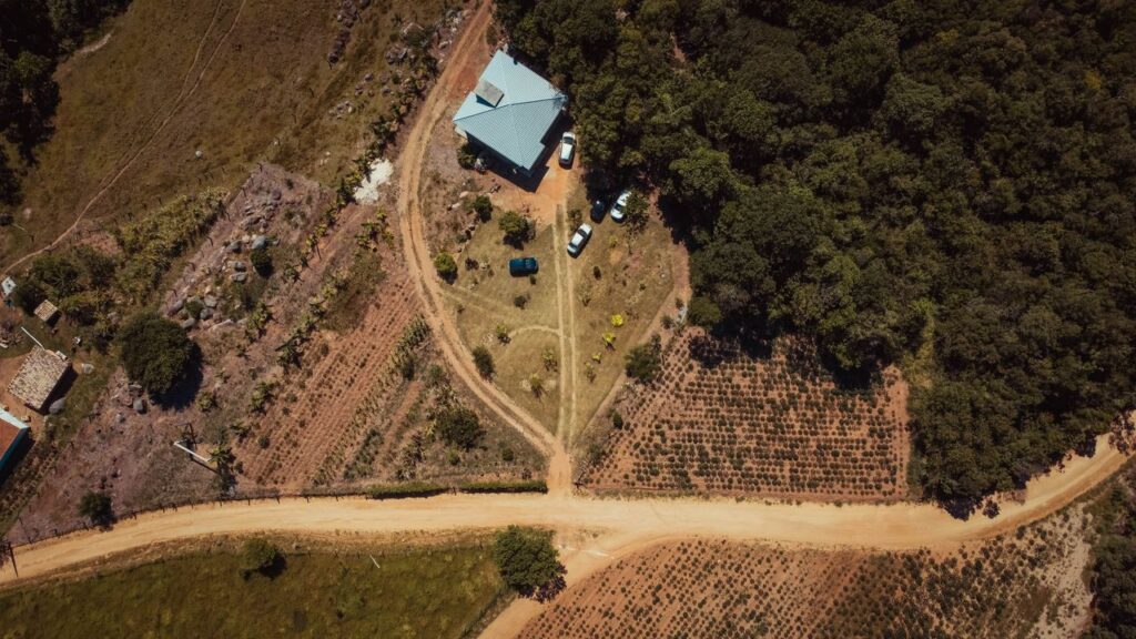 Aerial view of a rural countryside with a house and fields in Tubarão, Brazil.
