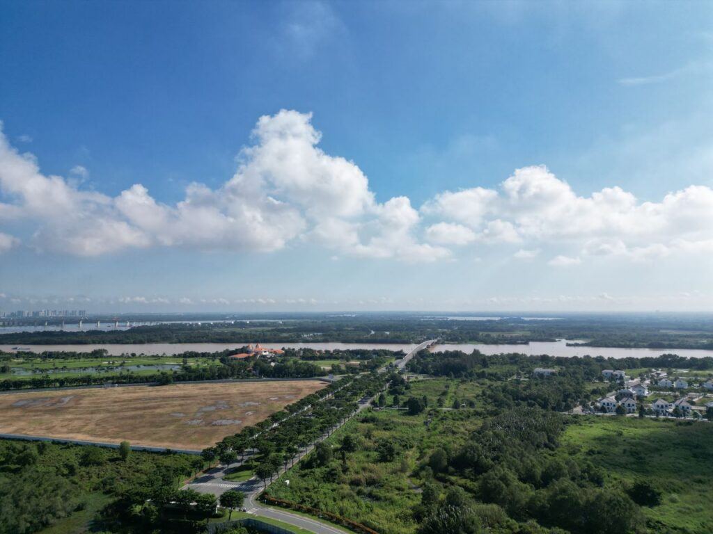 A breathtaking aerial view of Dong Nai's lush countryside under a bright blue sky.