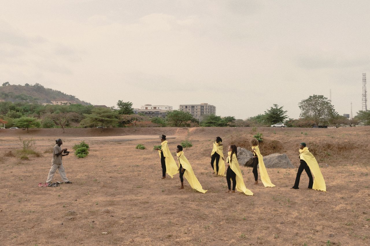 Fashion models in yellow wraps during an outdoor shoot in Abuja, Nigeria.